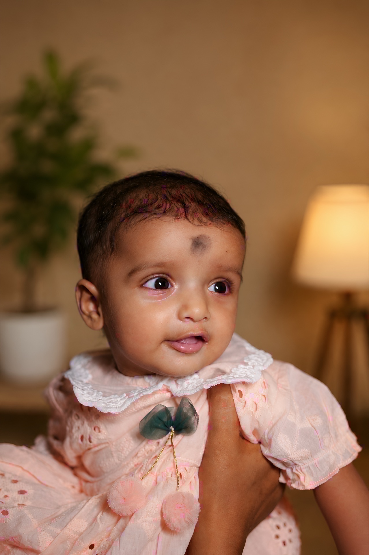 Baby looking up with wonder in parent's loving arms