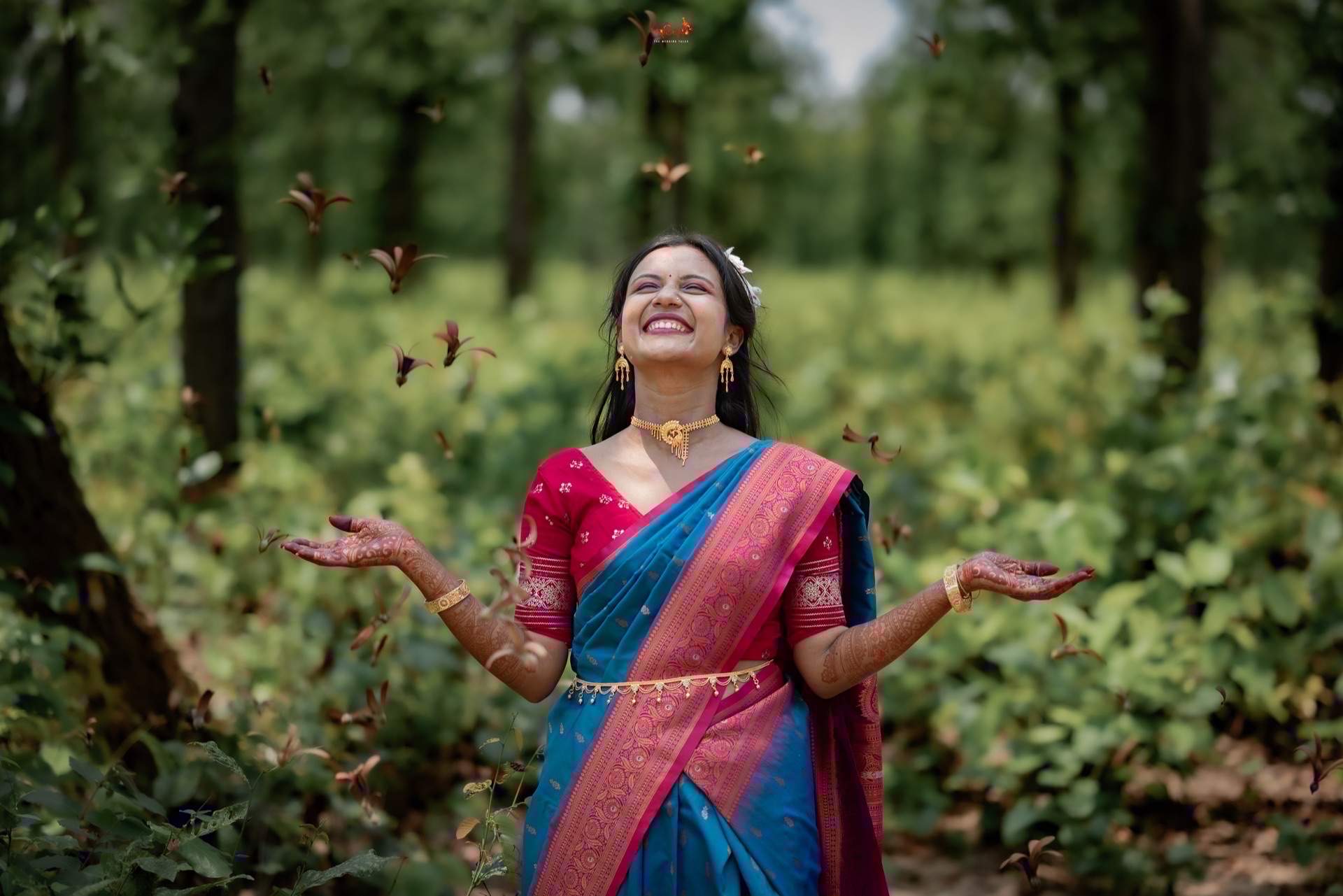 Joyful Bengali bride Dhritidipa celebrating in lush nature with mehendi