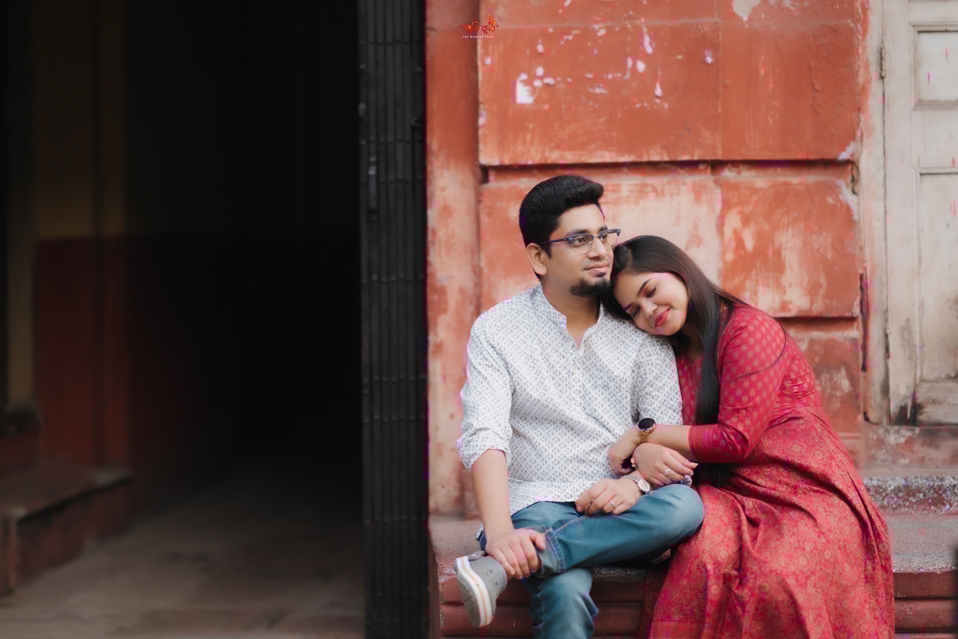 Neha smiling at Avronil in vibrant red attire